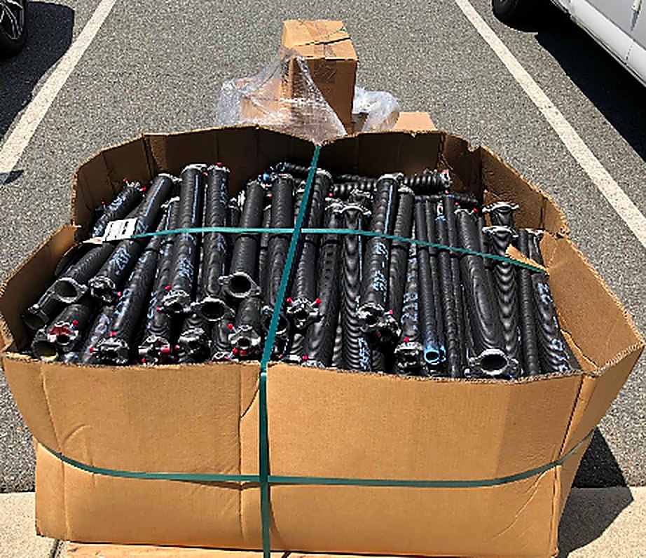 Pallet of new garage door torsion springs ready for installation