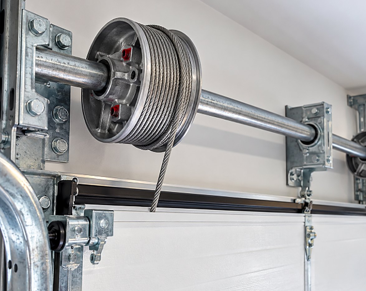 Close up of a garage door cable drum with wound lift cable