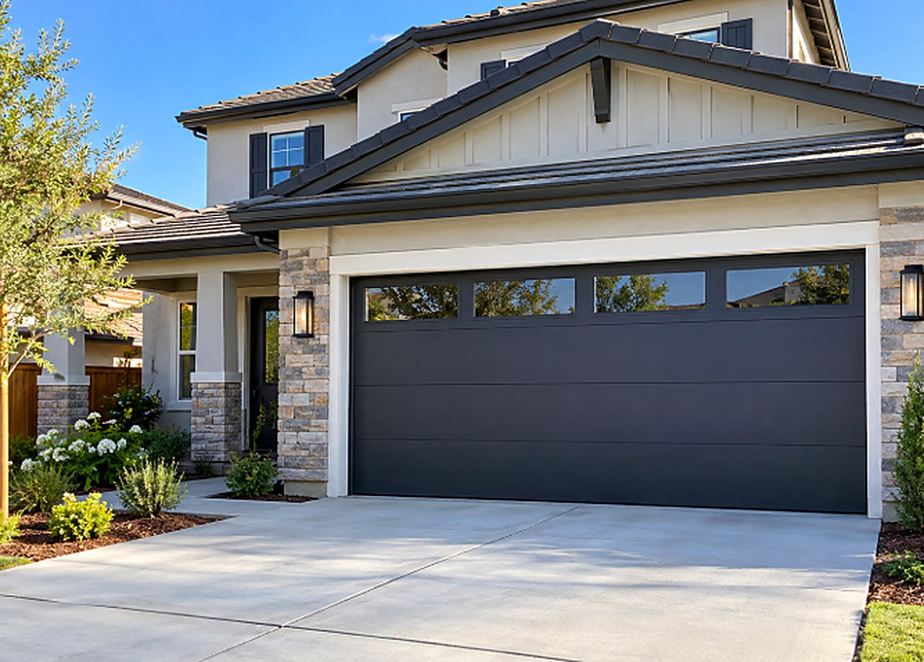 Modern dark garage door with window inserts installed on a home